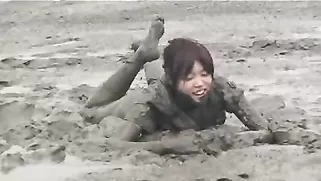 Dirty Japanese Doll Falls On Grey Dirt Without Getting Naked