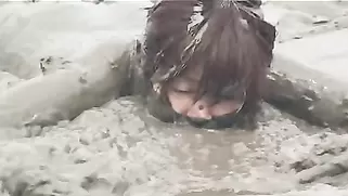 Dirty Japanese Doll Falls On Grey Dirt Without Getting Naked